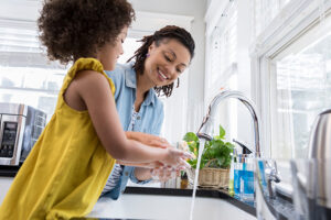 Mother and daughter at kitchen sink