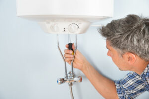 plumber demonstrating how to drain a water heater in sarasota fl